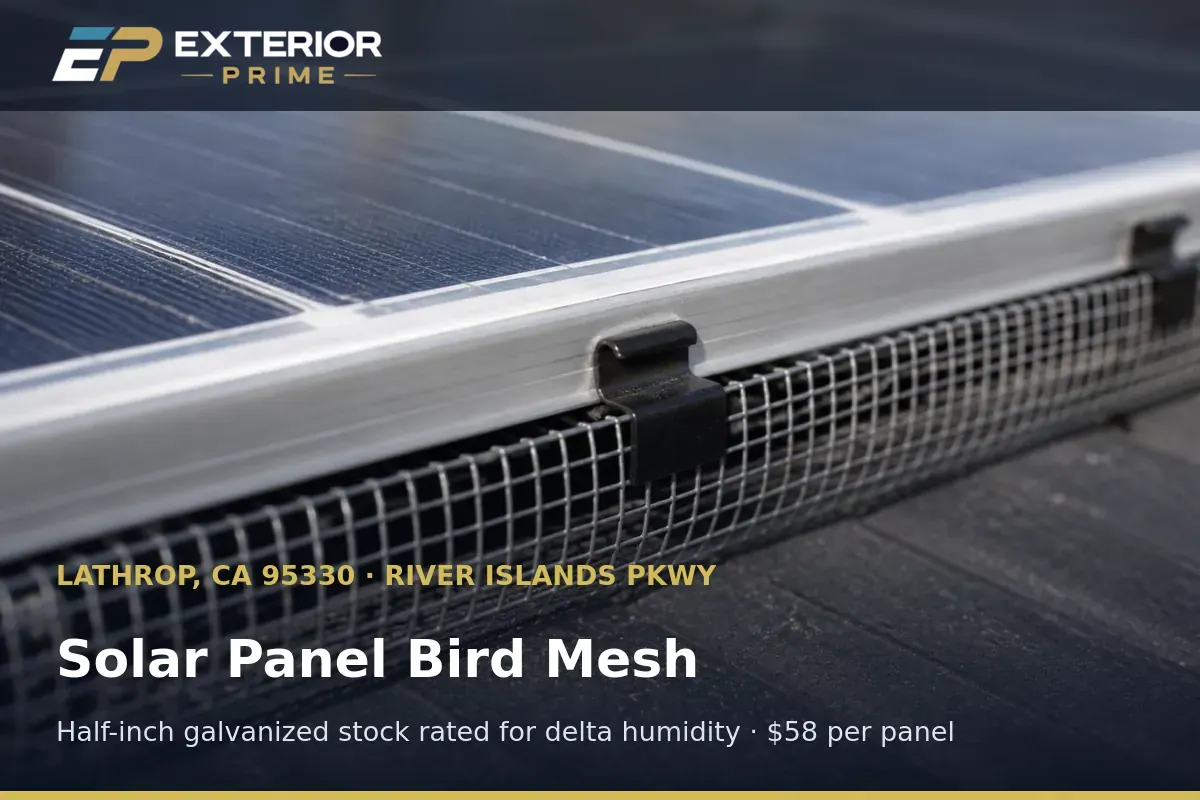 Half-inch galvanized bird mesh sized flush to the lower rail of a rooftop solar module in Lathrop, CA