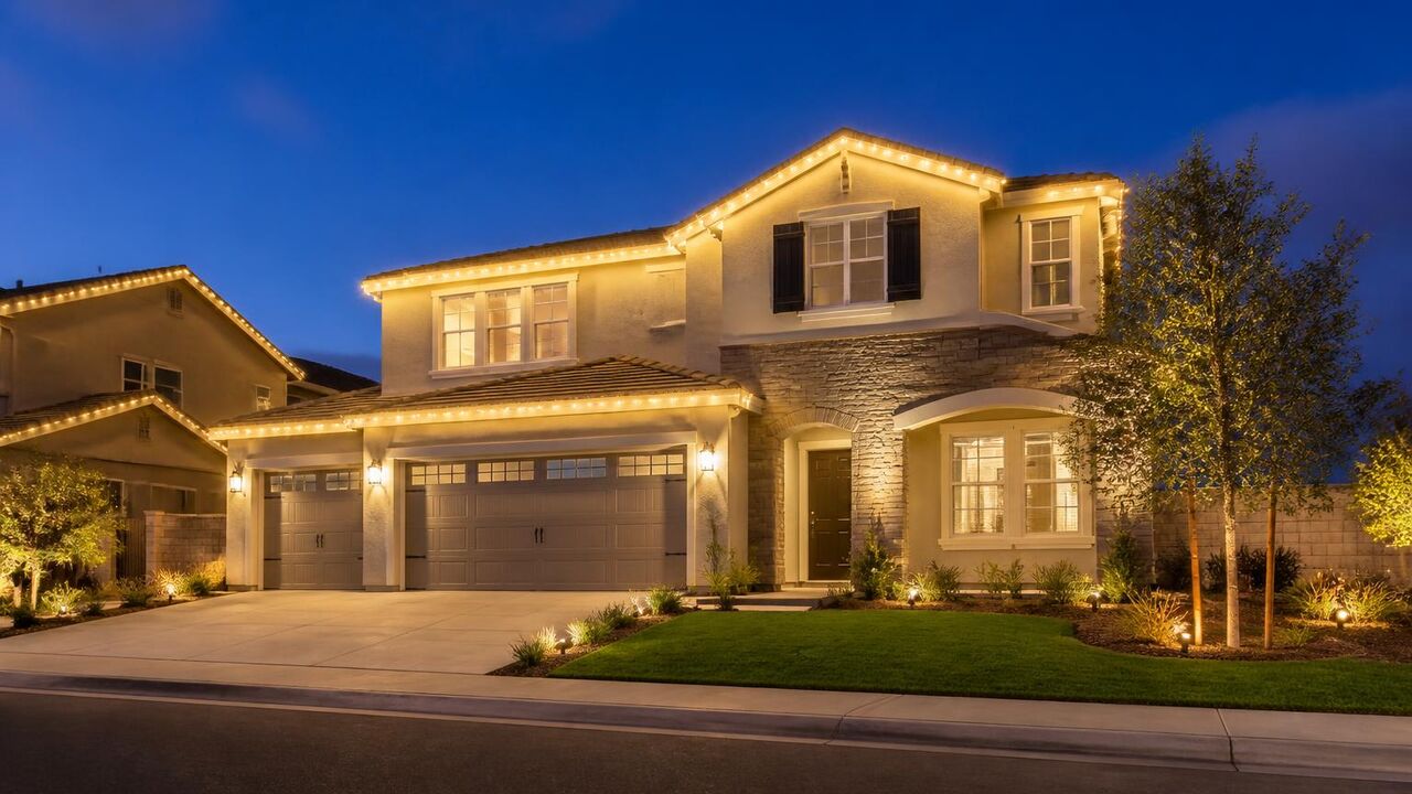Permanent warm white roofline lighting on a new River Islands home in Lathrop, CA photographed at dusk