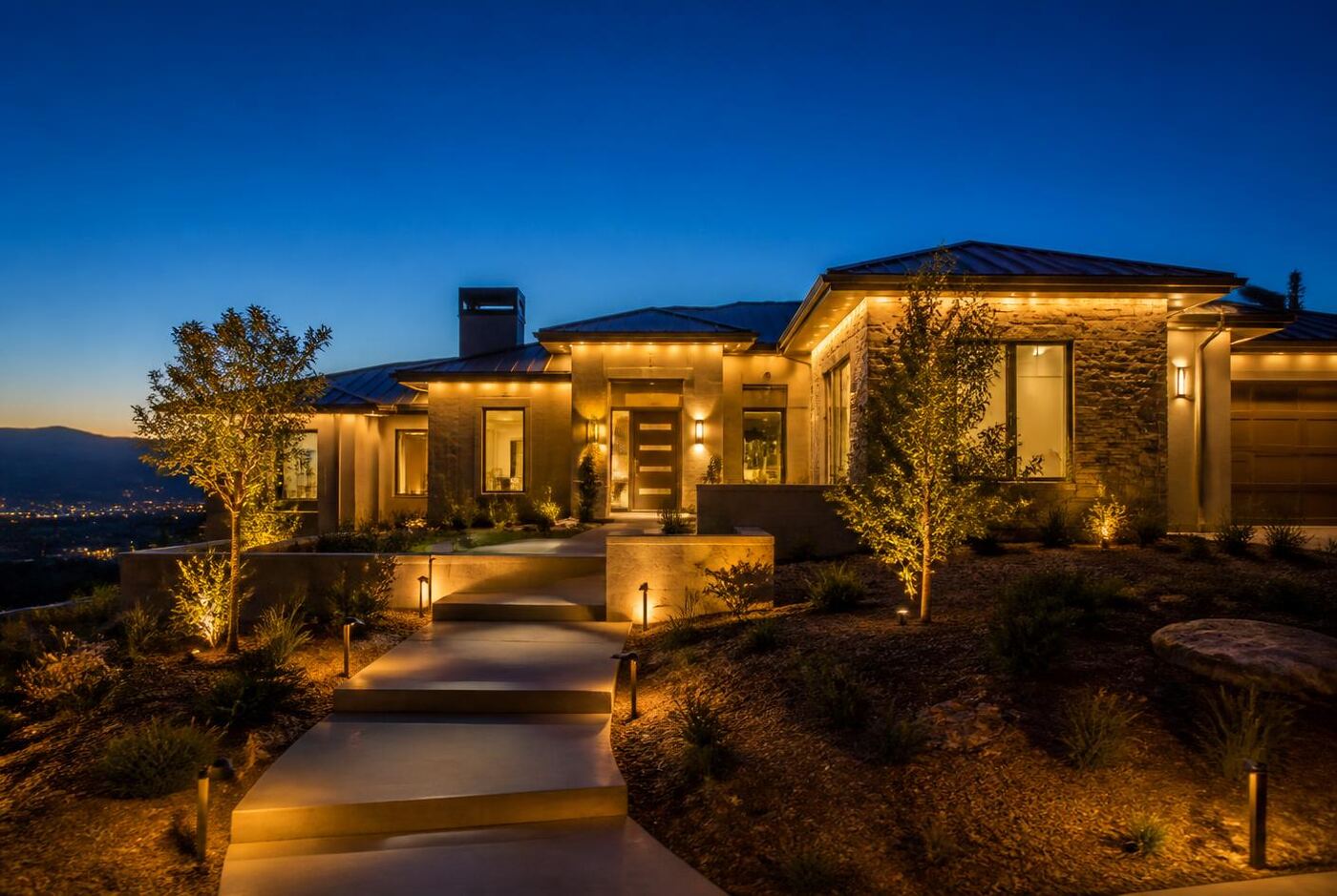 Warm white permanent exterior lighting used as year-round architectural accent lighting on a single-story home