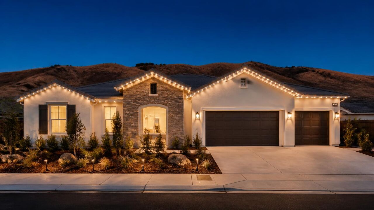 Permanent warm white roofline lighting on a Tracy Hills home in Tracy, CA photographed at dusk
